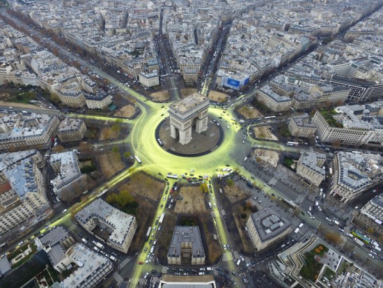 Greenpeace activists create a solar symbol around the world-famous Paris landmark, the Arc de Triomphe.